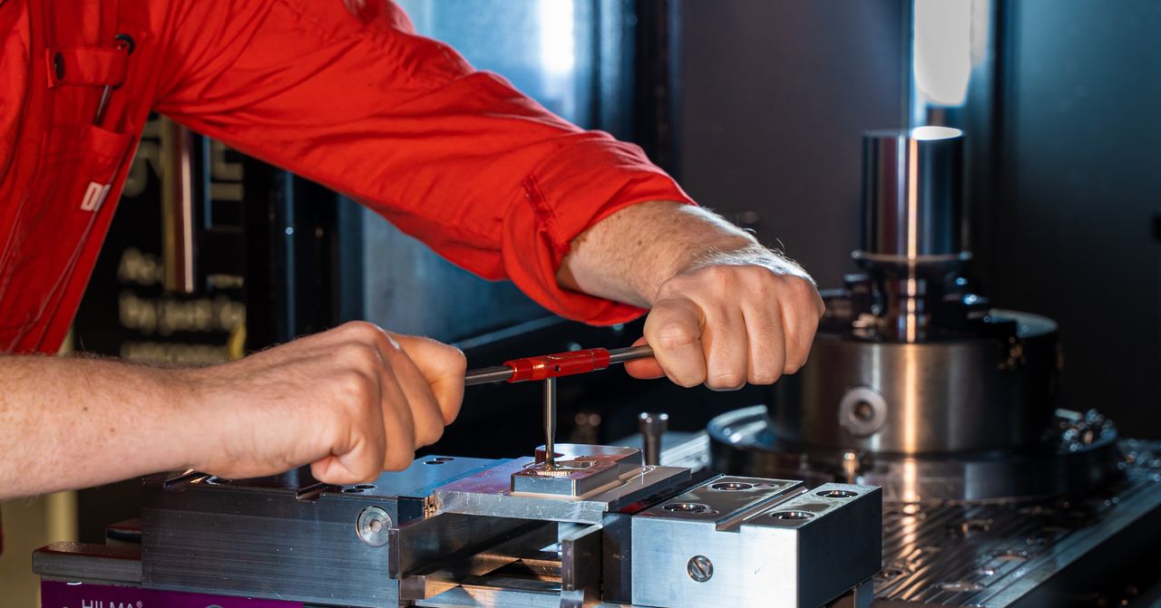 Operator tapping an internal thread in a prepared metal hole